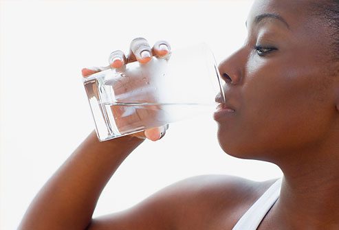 Person drinking water from a glass.
